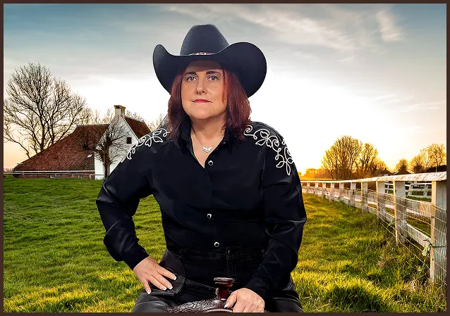 Joanne Wesloske in a black hat with a horse image behind her.