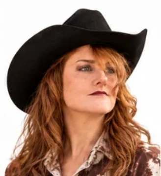 A close-up portrait of Joanne Wesloske wearing a black cowboy hat.