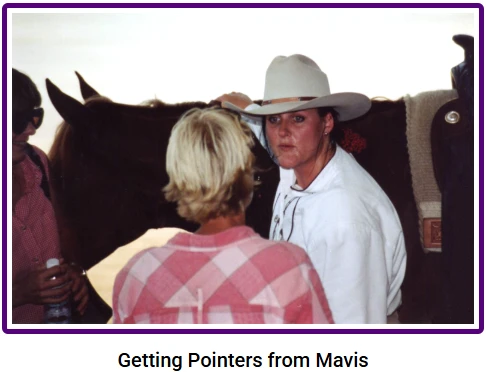 Getting pointers from Mavis Garber beside a saddled horse.